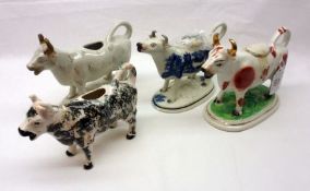 A small collection of Staffordshire Cow Creamers, comprises an iron red example; a blue Willow