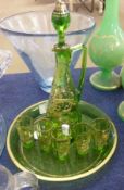A Decorative early 20th Century Green Glass Liquor Set, comprises a Decanter gilded with scrolls and