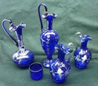 A group of four Blue Glass and Floral Decorated Ewers; together with a small Bristol Blue Glass