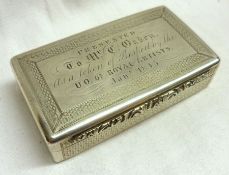 An early Victorian Snuff Box of rectangular shape, with plain chamfered edges, engine turned