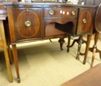 An early 20th Century Mahogany Serpentine Front Sideboard, fitted with narrow central drawer,