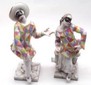 A pair of 20th Century Capodimonte Models of male and female harlequin figures, wearing multi-