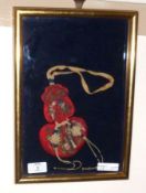 A 20th Century Oriental Embroidered Pouch in a framed and glazed case, 12” x 8 ½”