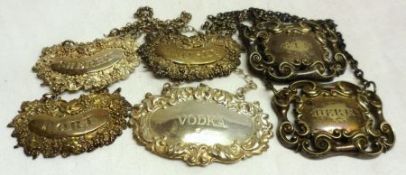 A Mixed Lot comprising: A set of three Victorian Wine Labels, cartouche shaped with embossed