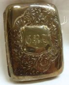 A late Victorian Cigarette Case of curved rectangular form, foliate engraved, later applied
