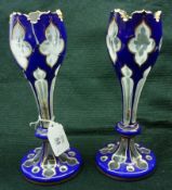 A pair of Bohemian glass baluster Vases with hipped rims, slender stems terminating in spreading