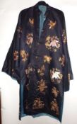 A late 19th/early 20th Century Chinese Navy Blue Silk Robe, embroidered with crane, insect and