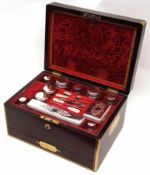 An early Victorian Rosewood cased Vanity Set, the case in Military style with Brass edges, incut