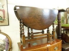An 18th Century Oval Oak Gateleg Table, single end drawer with brass ring handle to bobbin-turned