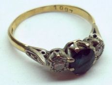 A hallmarked 18ct Gold centre oval Sapphire and two small old cut Diamond Ring