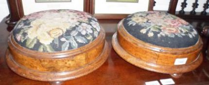 A pair of Victorian Round Walnut Framed and Tapestry Topped Footstools, raised on compressed bun