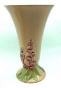 A Clarice Cliff Newport Pottery Conical Vase with raised floral detail on a pink background, 12”