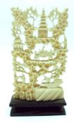 A Carved Ivory or Bone Model of a riverboat, trees, figures etc on an ebonised stand, 4” high