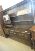An 18th Century and later Oak Dresser, the three drawer base with brass swan neck handles and