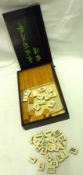 A 20th Century Mah-jong Set including a fitted Box of Counters, four various Trays and two