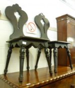 A pair of Victorian Dark Stained Oak Hall Chairs, the trefoil shaped backs to a hard seat, raised on