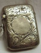 A late Victorian small Vesta, rectangular shaped with foliate engraving and vacant cartouche, (