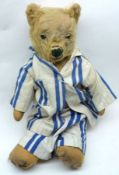 An early 20th Century Teddy Bear, attributed to Chad Valley, blonde mohair covered with swivel head,