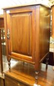 A late Victorian Mahogany single door Bedside Cabinet, the panelled door to a shelved interior,