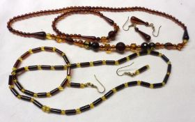 A Baltic Amber (Deep Cognac) Set of Necklet and matching Earrings; together with a Tube Amber Set of