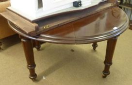 A Mahogany Extending Dining Table with moulded edge, plain frieze and raised on ring-turned tapering