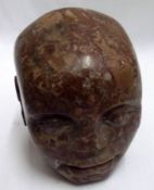 A Carved Marble or Hardstone Bust of a primitive head, 4 ½” high