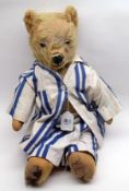 An early 20th Century Teddy Bear, attributed to Chad Valley, blonde mohair covered with swivel head,