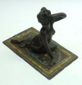 A Reproduction Bronze Patinated Metal Model of a girl seated on a magic carpet, the base marked