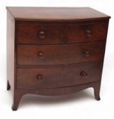 An early 19th Century Mahogany Bow Front Chest of Two Short and Two Long Drawers, terminating in