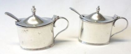A pair of plain oval Mustards with hinged domed lids (one hinge broken), complete with blue glass