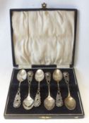 An early 20th Century Cased Set of six Continental white metal Coffee Spoons, having cast rose and