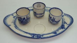 An Oval Royal Doulton “Norfolk” pattern Egg Cruet with three (of four) eggcups, typically