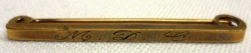 A small yellow Bar Brooch of plain design, bearing initials MDC, 37mm long, stamped “9ct”,