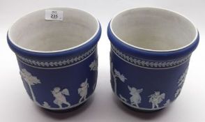 A pair of Blue Wedgwood Jasperware Jardinières, typically decorated with cherubs and foliage, 6 ½”