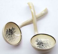 A pair of unusual Royal Doulton “Norfolk” pattern Ladles, decorated in black, approx 6” long