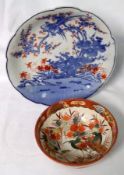 A Kutani Circular Bowl, the centre decorated in typical colours with exotic bird amidst foliage;