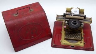 A 1920s German Tinplate Junior Model Typewriter with USA Patent Design, housed within original red