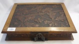 A late Victorian heavily carved Book-shaped Table Top Box with fitted interior, the front