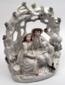 A 19th Century Staffordshire Bocage Group, of a young man and woman with a dog, flesh colour and