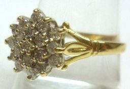 A hallmarked 18ct Gold nineteen small Brilliant Cut Diamond Flower Head Design Cluster Ring