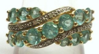 A hallmarked 9ct Gold Dress Ring, set with three bands of blue Apatite Stones in crossover style