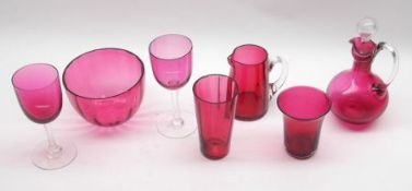 A small collection of Cranberry Glass, comprising two Stemmed Glasses, two Beakers, a Jug, a Sugar