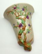 A Clarice Cliff Newport Wall Pocket, moulded with a branch design and decorated in colours, 9” high