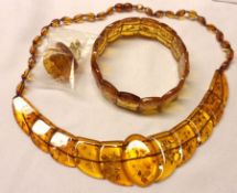 A Warm Light Cognac Amber Necklace and Bracelet Set, with shaped asymmetric panels, weighing