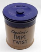 A Vintage Stoneware “Ogden’s Impi Twist” Covered Jar of circular form (hairline crack), 6 ¾” high