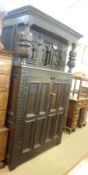 A large 19th Century Oak Court Cupboard, the top with two heavy doors with arched detail, the base