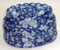 An Oval Turreted Form Jelly Mould with blue and white floral decoration, 7 ½” long