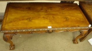 A Reproduction Georgian style Rectangular Walnut Coffee Table, the top with carved frieze, raised on