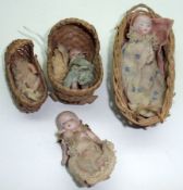 Four early 20th Century all bisque Infant Dolls, (Doll House Miniatures)