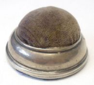A Silver mounted small circular Pin Cushion, 2 ½” diameter, marks nearly erased